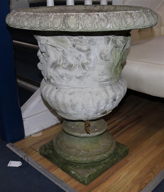 A pair of cherub embossed stone garden urns, H.65cm